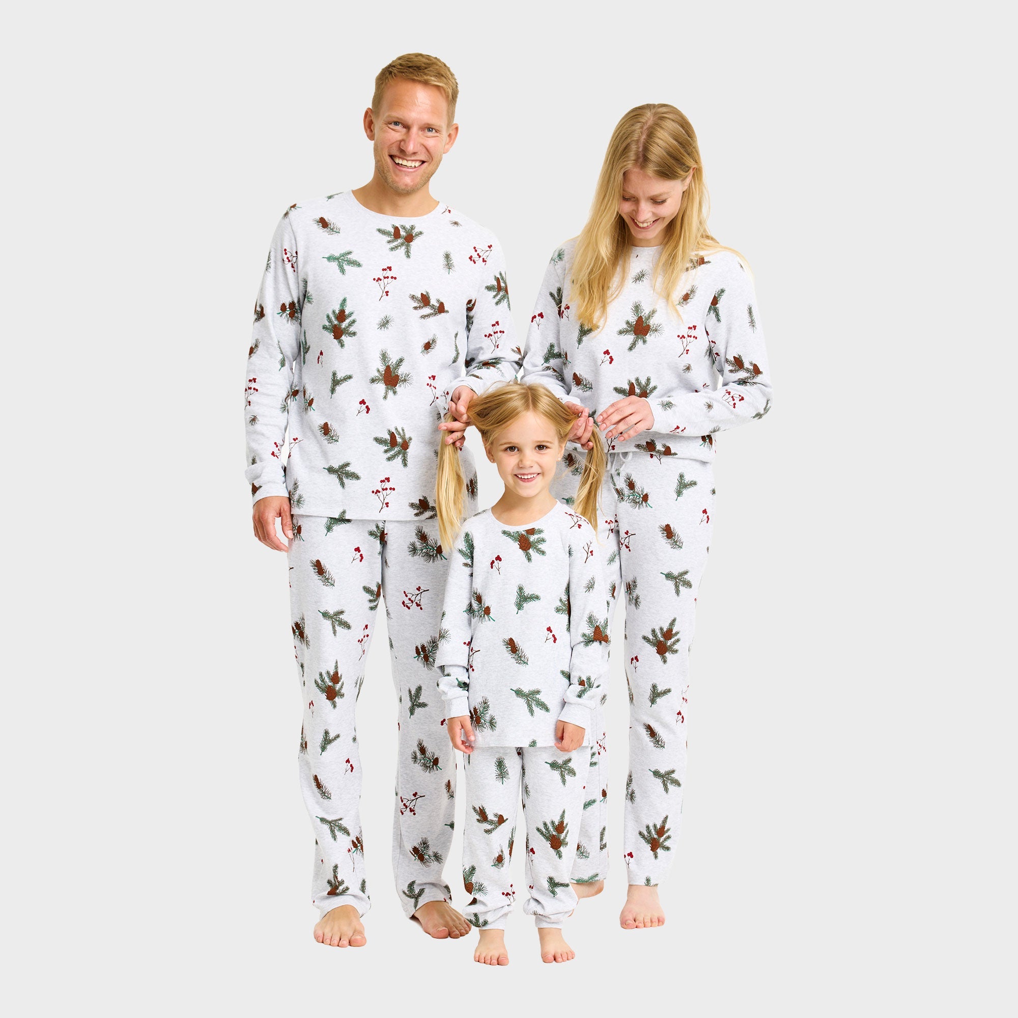 Weihnachtspyjama Herren, Damen und Kinder mit Schneeflocken- und Rentiermuster in Weiß.